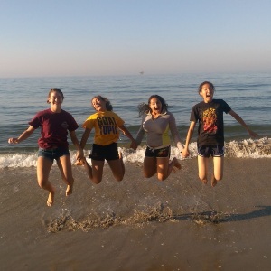 Gaines Lab summer interns celebrating another successful sandy beach survey at dawn. From left to right: Emma Horanic, Carina Motta, Dominique Whittle, Amy Ju.
